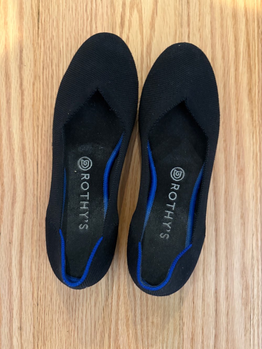 Rothy's Woman’s Black Slip-On Flats with Blue Trim